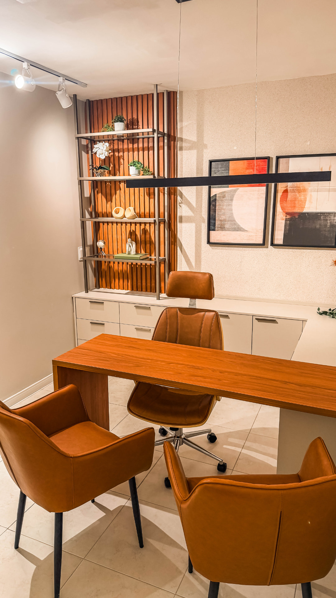Sala premium com mesa de madeira e quadros